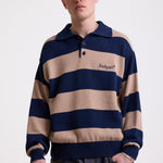 Navy and stone stripe knit polo jumper with Rockport embroidery logo at chest, worn by a model