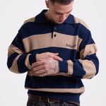 Navy and stone stripe knit polo jumper with Rockport embroidery logo at chest, worn by a model