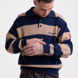 Navy and stone stripe knit polo jumper with Rockport embroidery logo at chest, worn by a model