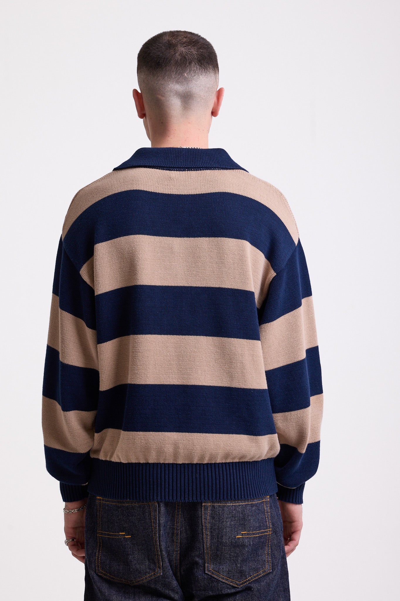 Navy and stone stripe knit polo jumper with Rockport embroidery logo at chest, worn by a model