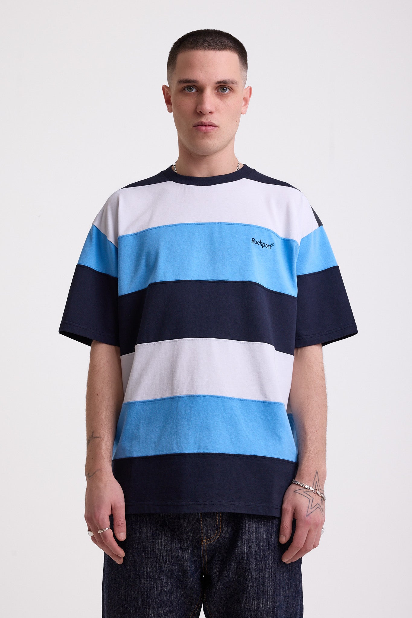 Navy, blue and white stripe crew neck t-shirt with embroidered Rockport logo, worn by model