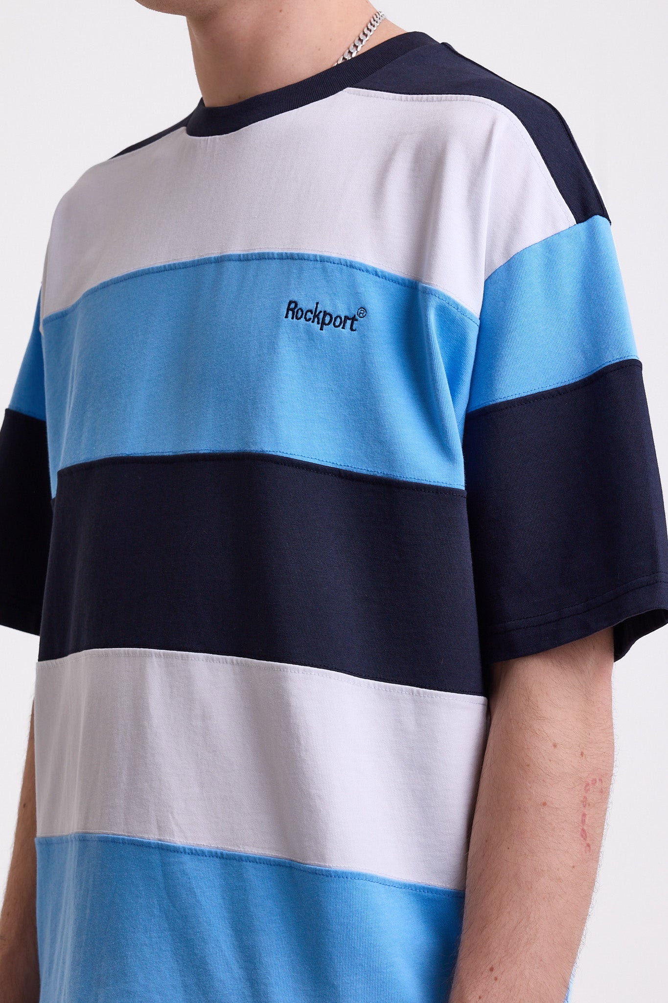 Navy, blue and white stripe crew neck t-shirt with embroidered Rockport logo, worn by model