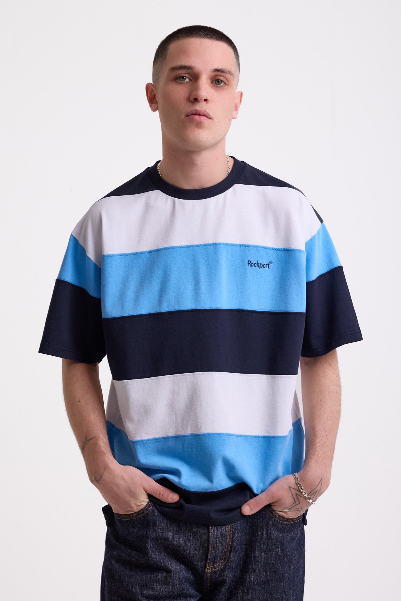 Navy, blue and white stripe crew neck t-shirt with embroidered Rockport logo, worn by model