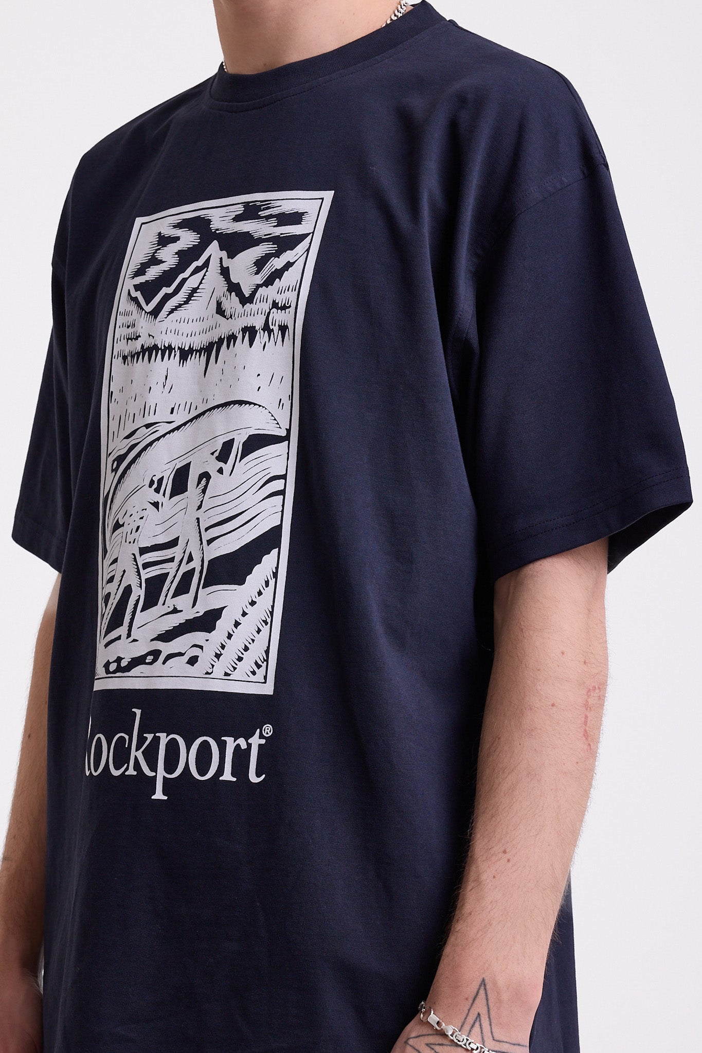 Navy crew neck t-shirt with printed ourdoor-inspired graphic and Rockport logo, worn by model