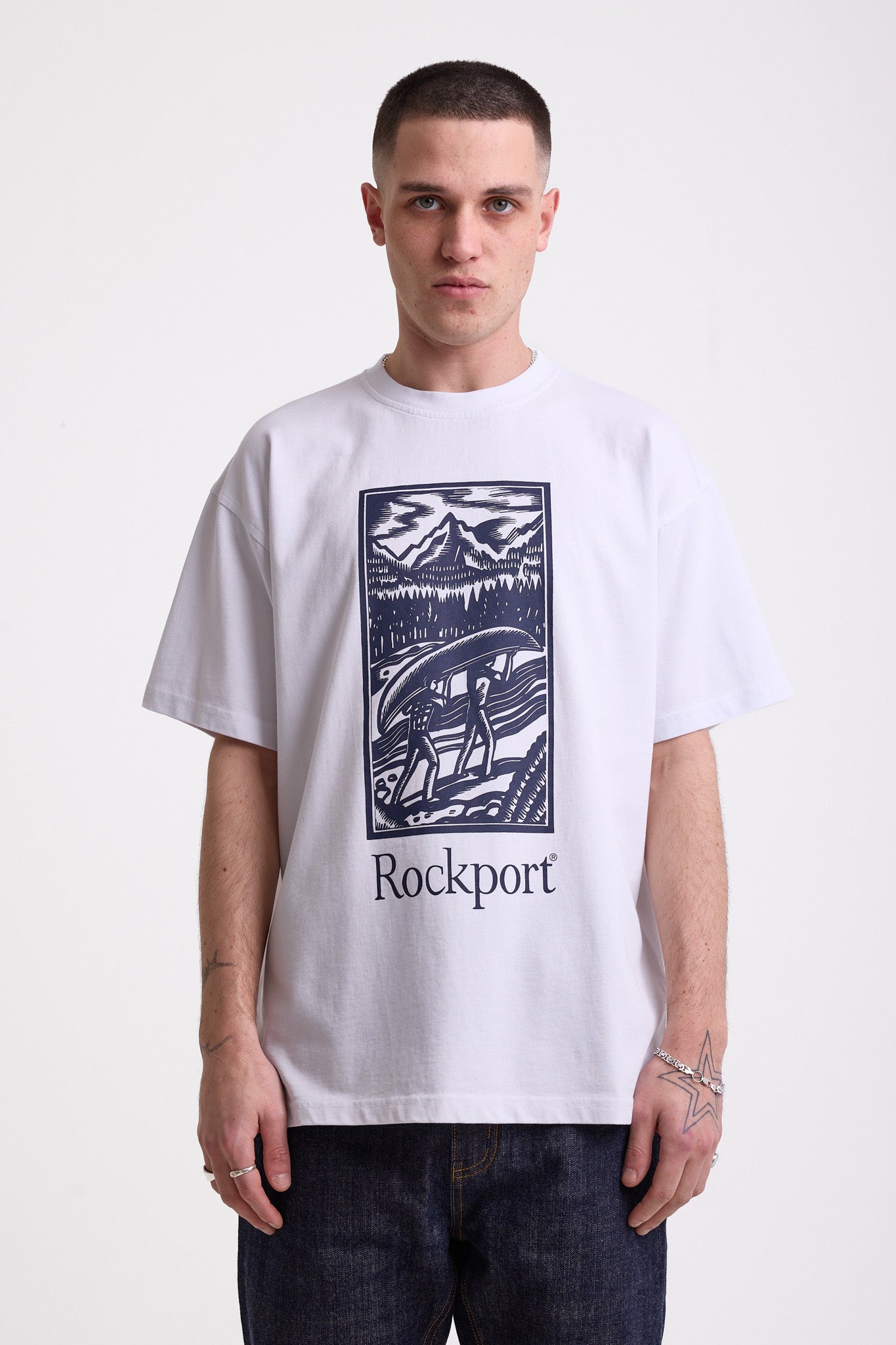 White crew neck t-shirt with printed ourdoor-inspired graphic and Rockport logo, worn by model