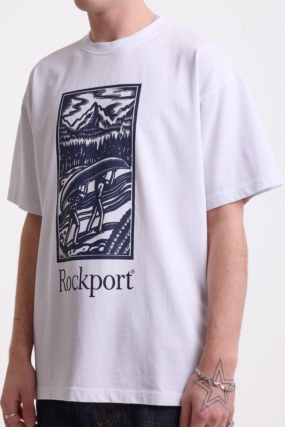 White crew neck t-shirt with printed ourdoor-inspired graphic and Rockport logo, worn by model