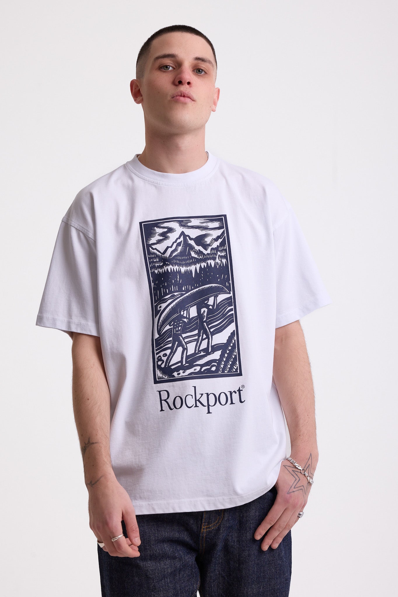 White crew neck t-shirt with printed ourdoor-inspired graphic and Rockport logo, worn by model