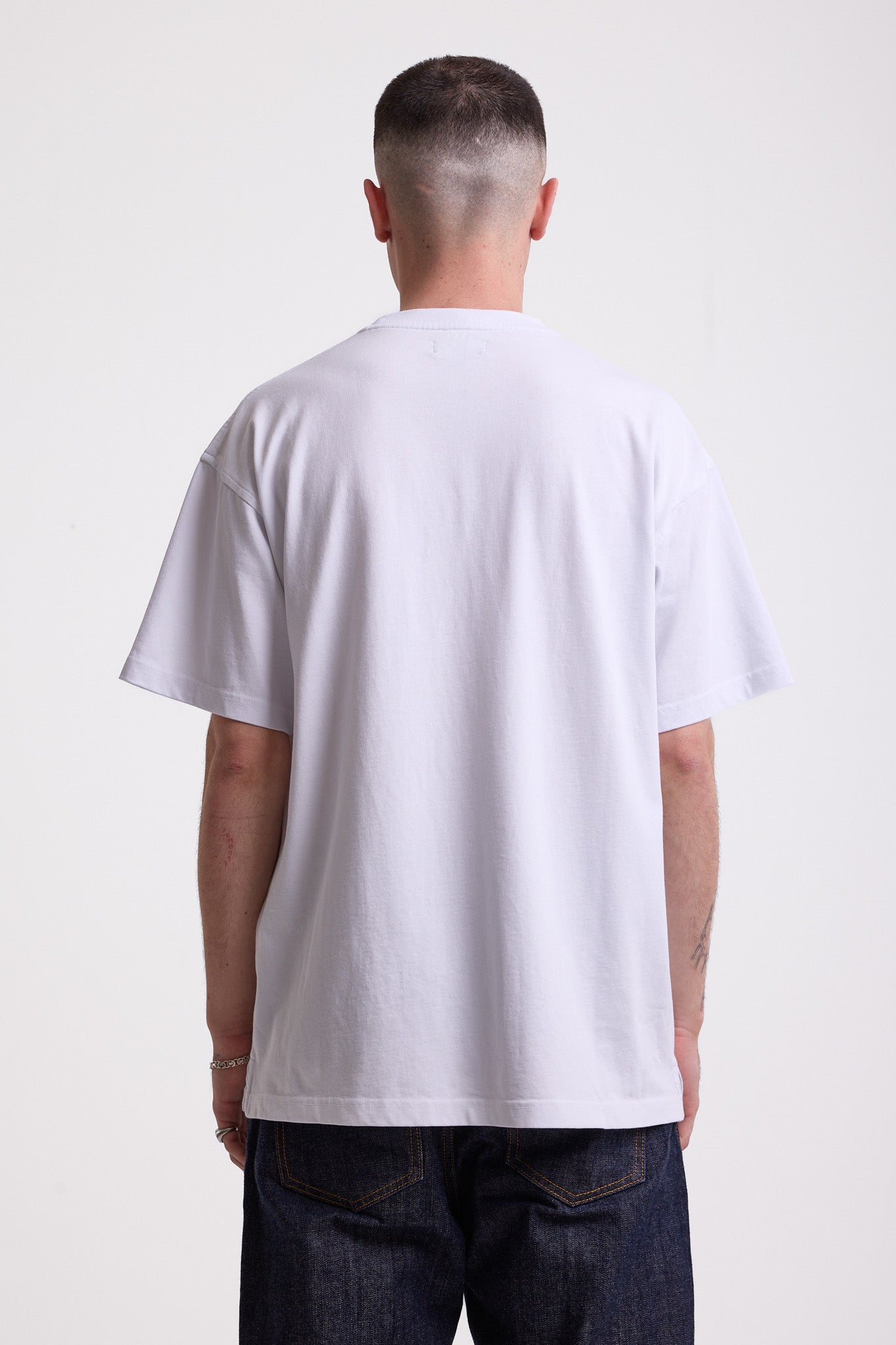 White crew neck t-shirt with printed ourdoor-inspired graphic and Rockport logo, worn by model