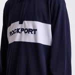 Navy long sleeve pique polo shirt with contrast chest panel and appliqué Rockport logo, worn by model