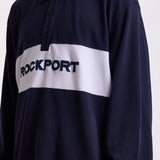 Navy long sleeve pique polo shirt with contrast chest panel and appliqué Rockport logo, worn by model