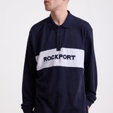 Navy long sleeve pique polo shirt with contrast chest panel and appliqué Rockport logo, worn by model
