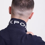 Navy long sleeve pique polo shirt with contrast chest panel and appliqué Rockport logo, worn by model