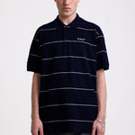 Navy and white striped pique polo shirt with embroidered Rockport logo, worn by model