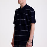 Navy and white striped pique polo shirt with embroidered Rockport logo, worn by model