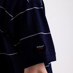 Navy and white striped pique polo shirt with embroidered Rockport logo, worn by model