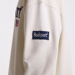 Ecru cotton crew neck sweatshirt with embroidered Rockport logo and american flag at chest, worn by model