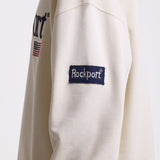 Ecru cotton crew neck sweatshirt with embroidered Rockport logo and american flag at chest, worn by model