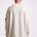 Ecru cotton crew neck sweatshirt with embroidered Rockport logo and american flag at chest, worn by model