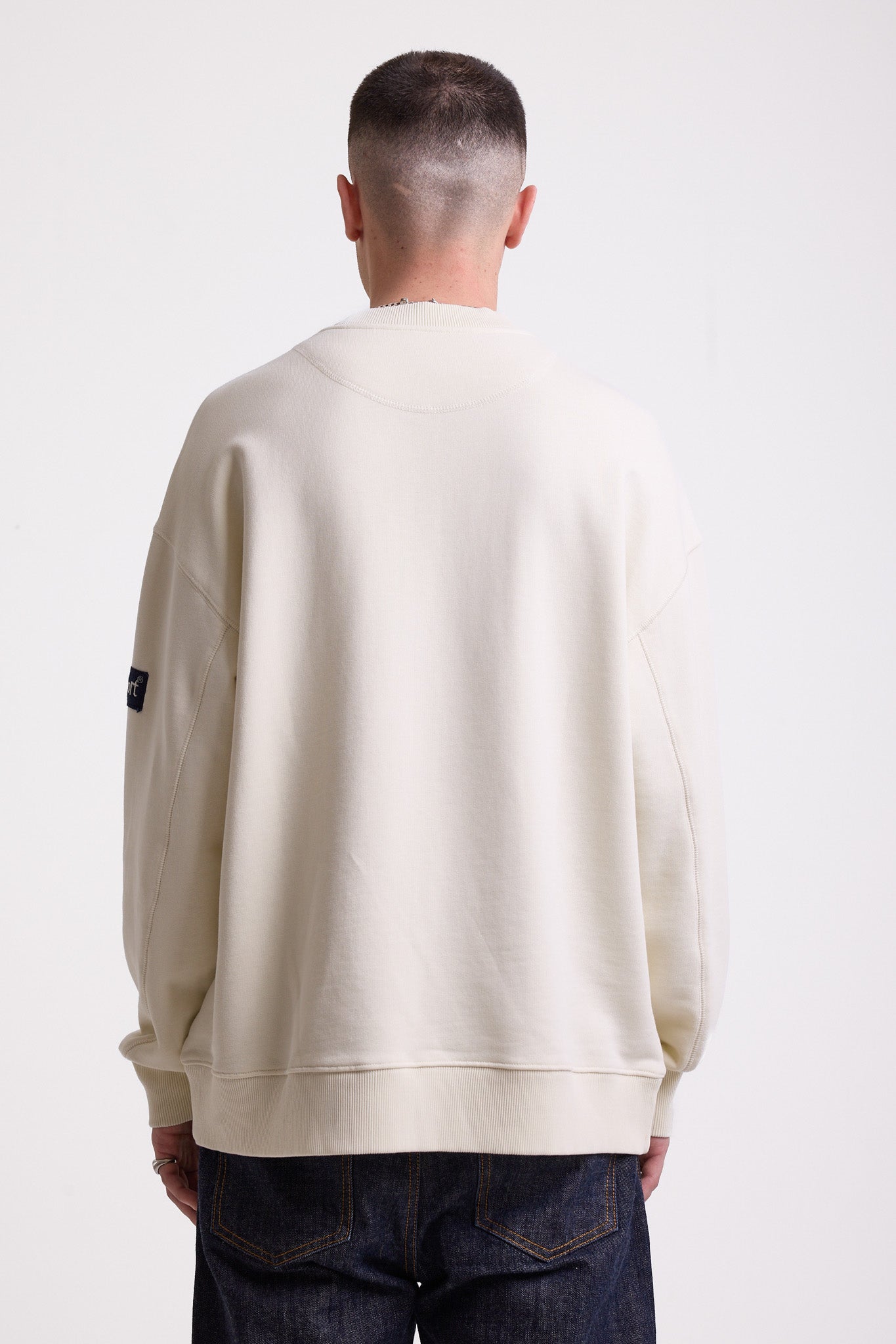 Ecru cotton crew neck sweatshirt with embroidered Rockport logo and american flag at chest, worn by model