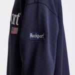 Navy cotton crew neck sweatshirt with embroidered Rockport logo and american flag at chest, worn by model
