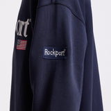 Navy cotton crew neck sweatshirt with embroidered Rockport logo and american flag at chest, worn by model