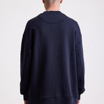 Navy cotton crew neck sweatshirt with embroidered Rockport logo and american flag at chest, worn by model
