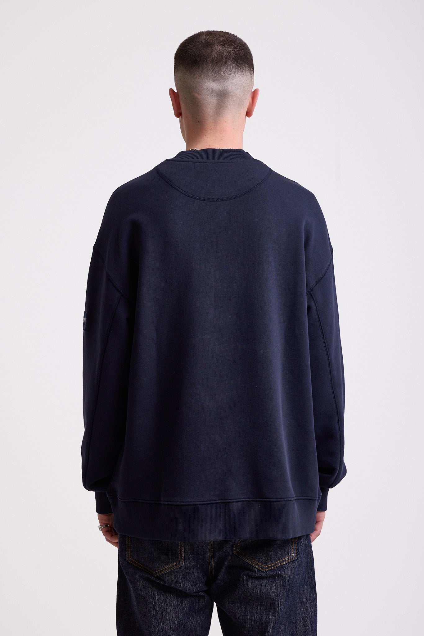 Navy cotton crew neck sweatshirt with embroidered Rockport logo and american flag at chest, worn by model