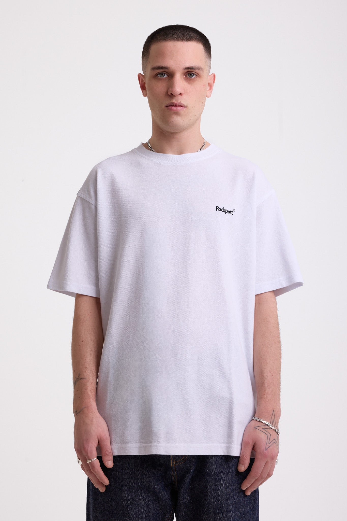 White pique crew neck t-shirt with navy Rockport embroidery, worn by model