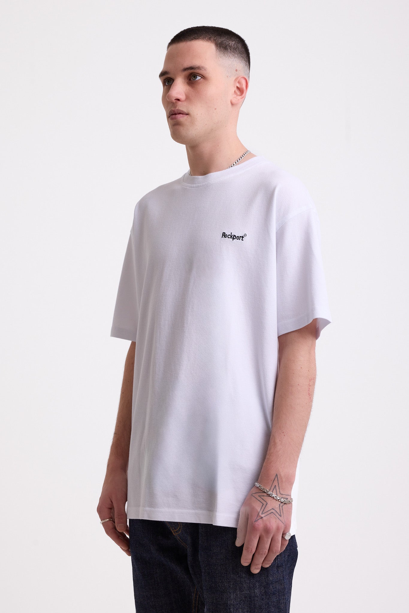 White pique crew neck t-shirt with navy Rockport embroidery, worn by model