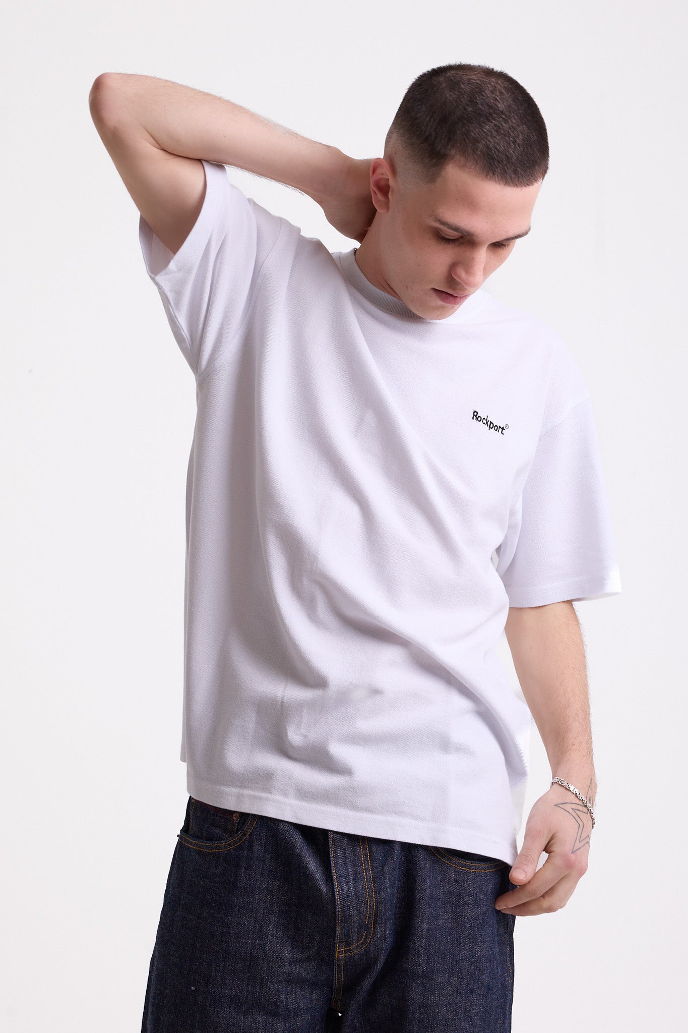 White pique crew neck t-shirt with navy Rockport embroidery, worn by model