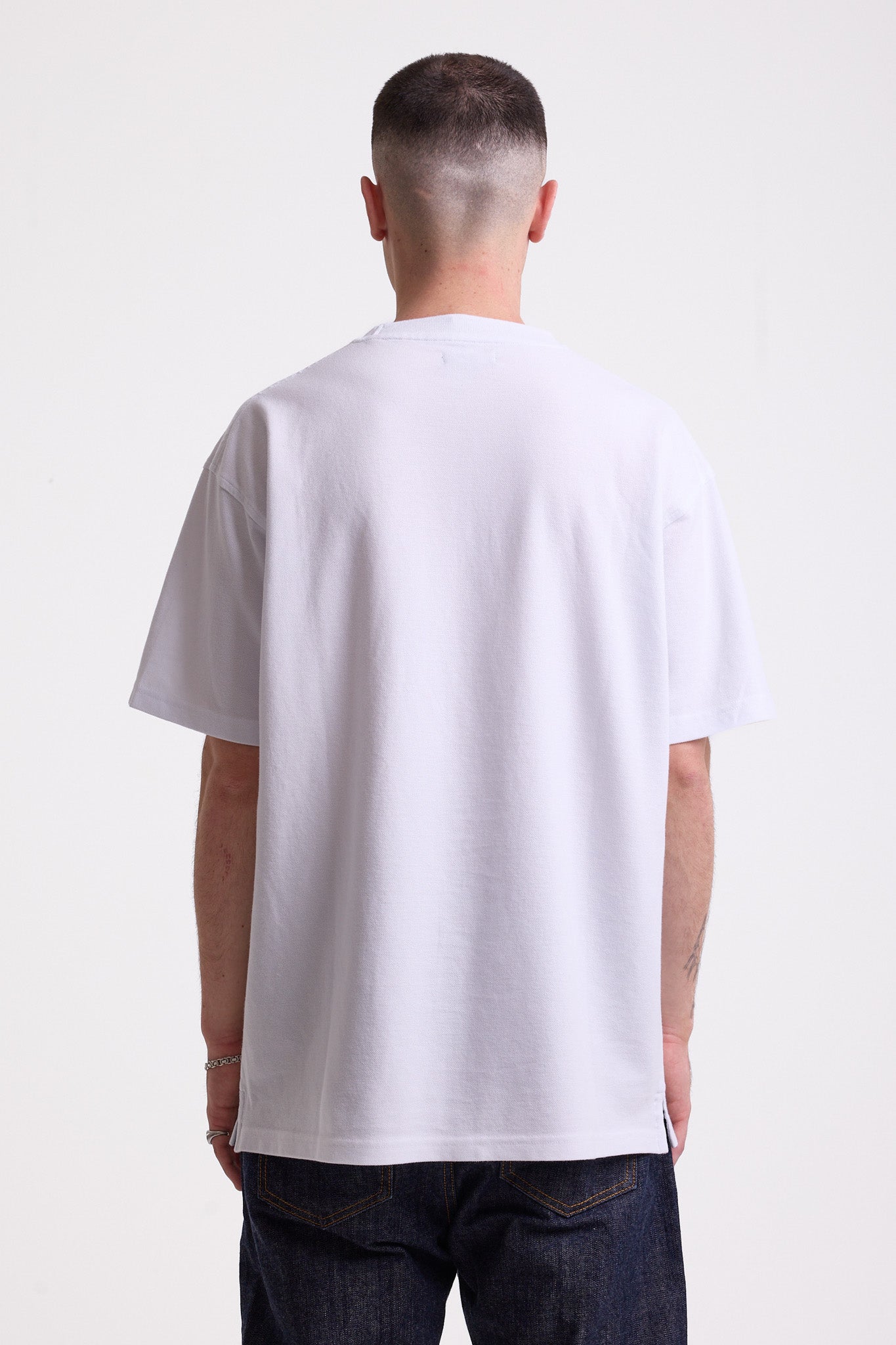 White pique crew neck t-shirt with navy Rockport embroidery, worn by model