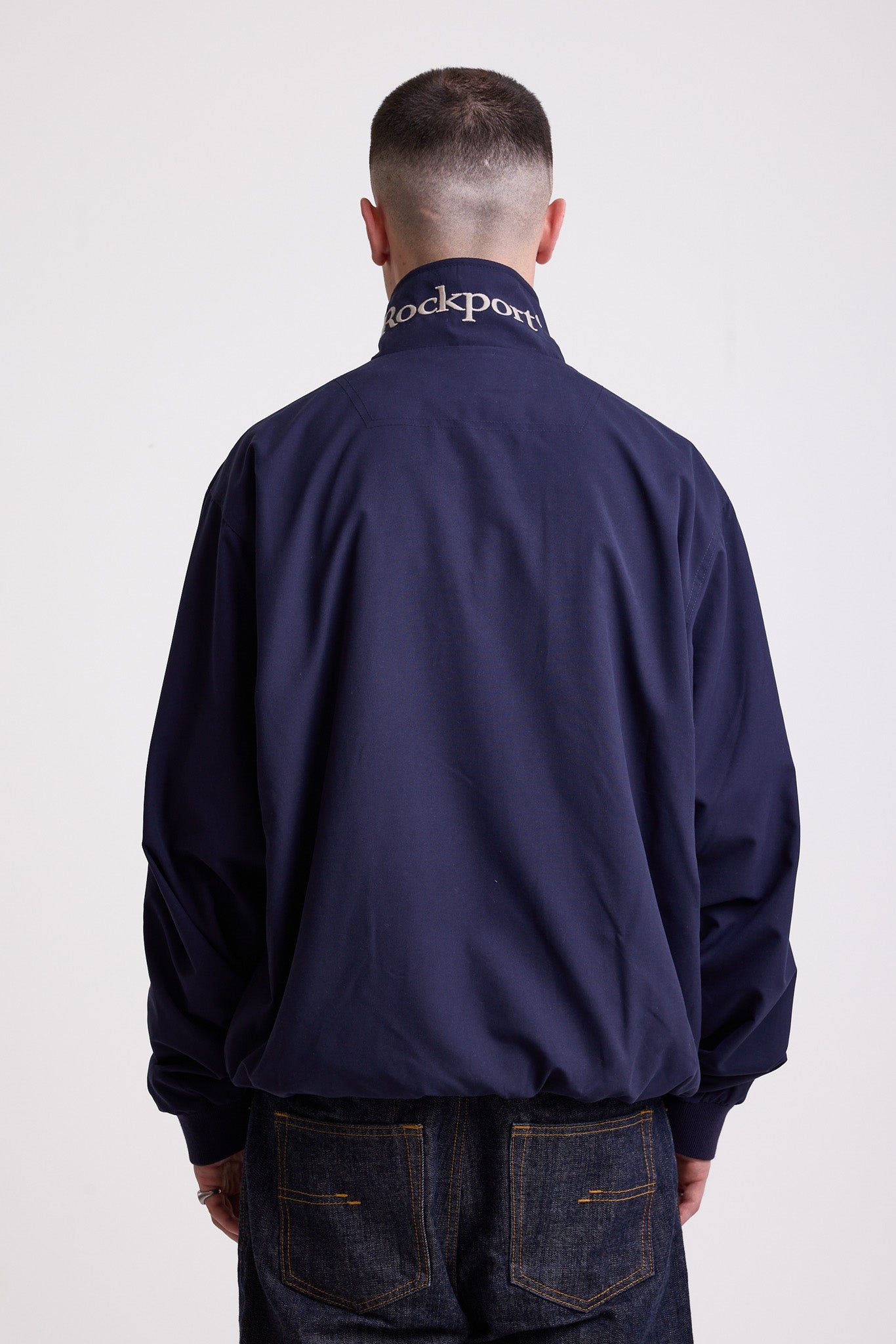 Classic navy harrington jacket with embroidered rockport logo, worn by model